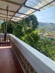 a balcony with a view of the mountains at Casa campestre in Jericó