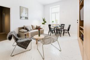a living room with a couch and chairs and a table at Apartamenty Browar Perła - free Parking in Lublin