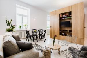 a living room with a couch and a table at Apartamenty Browar Perła - free Parking in Lublin