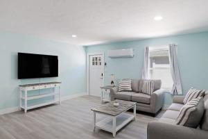 a living room with a couch and a flat screen tv at Superb Bonita Springs Residence Near Downtown in Bonita Springs