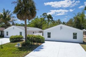 a white house with a palm tree in the driveway at Superb Bonita Springs Residence Near Downtown in Bonita Springs