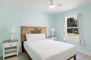 a bedroom with a white bed and a window at Superb Bonita Springs Residence Near Downtown in Bonita Springs