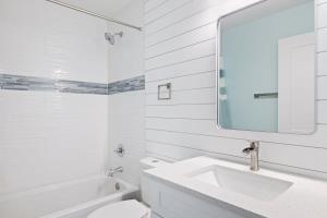 a white bathroom with a sink and a mirror at Superb Bonita Springs Residence Near Downtown in Bonita Springs