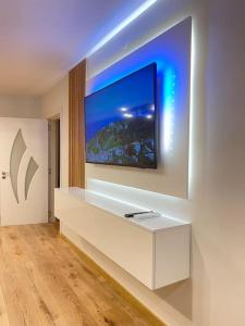 a living room with a large tv on a wall at Panorama Apartment in Plovdiv