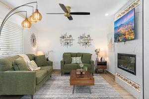 a living room with a couch and a tv at 3BD Spa & Heated Pool Old Town Vista Del Camino in Scottsdale