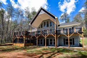 a house with a wrap around porch with a wrap around deck at Blue Sky in Hood