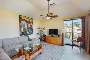 a living room with a couch and a tv at Shores at Waikoloa #323 in Waikoloa