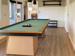 a pool table in a living room with afits at 8 person holiday home in Hemmet in Falen