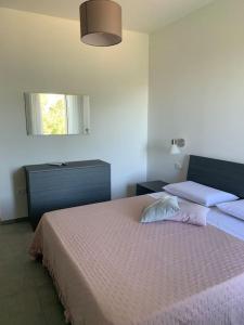 a bedroom with a large bed and a window at Tra borghi e mare - Ripatransone in Ripatransone