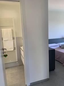 a bedroom with a bed and a door with a window at Tra borghi e mare - Ripatransone in Ripatransone +22 photos
