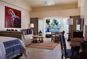 a bedroom with a bed and a living room at One&Only Palmilla in San José del Cabo