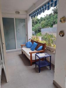 a porch with a couch and a table on a patio at Casa di Rosa al Negombo in Ischia
