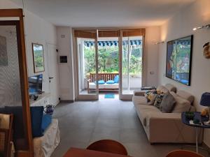a living room with a couch and a tv at Casa di Rosa al Negombo in Ischia
