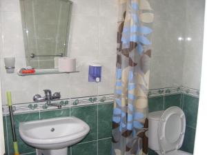 a small bathroom with a toilet and a sink at Guest House "Zora - Sarafovo" in Burgas +130 photos