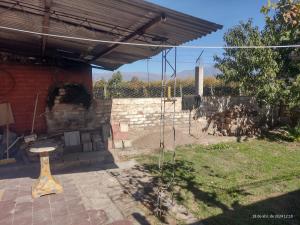 a patio with a brick building and a stone fireplace at Casa manu in La Consulta