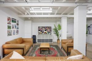 a living room with couches and a rug at The Queenslander! Complete Entertainer - Huge - Stylish - Games - Full Level Pool Room - Smokehouse - Secure Parking - Yard #NEW! in Gold Coast +25 photos