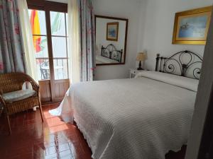 Postel nebo postele na pokoji v ubytování Hostal Gran Capitan