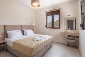 a bedroom with a bed and a bathroom with a sink at Tesoro luxury apartments in Sivota