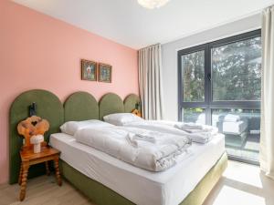 two beds in a room with pink walls at Lukasfeld 9 Top Sepp in Hopfgarten im Brixental