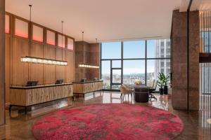 an office lobby with a red rug and a large window at W Taipei in Taipei