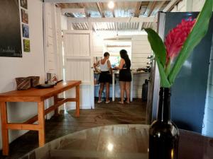 two people in a kitchen preparing food in a kitchen at Casa Hostal Amar-illa in El Valle