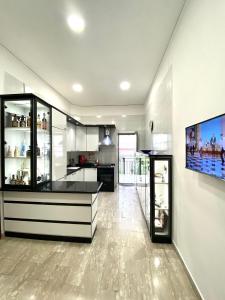 a kitchen with a counter and a tv on a wall at Castellano apartment in Naples