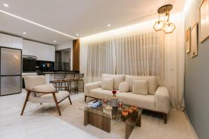 a living room with a couch and a table at Marina View Residence, Luxury Studio, Ocean View, Enjoy Starlink High Speed WiFi, IPTV, PlayStation PS4 Plus, Near TGV, Airport Bus, Taxi, Indrive, and so on in Tangier