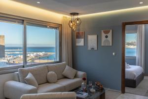 a living room with a couch and a view of the ocean at Marina View Residence, Luxury Studio, Ocean View, Enjoy Starlink High Speed WiFi, IPTV, PlayStation PS4 Plus, Near TGV, Airport Bus, Taxi, Indrive, and so on in Tangier