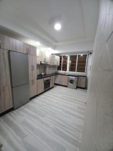 a large kitchen with wooden cabinets and a washer and dryer at Dari A310 in Agadir