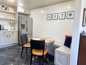 a kitchen with a table and chairs and a refrigerator at Campus Cottage Kng Bed! Walk To Uco And Downtown in Edmond