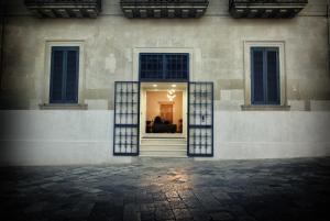 a building with a window with a couch in it at Manipinta B&B in Corigliano dʼOtranto