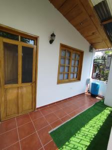 um quarto com uma porta e um relvado verde em Twin Casita #1 & #2 em San Pedro La Laguna