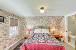 a bedroom with a bed and floral wallpaper at Charming Lovell Farmhouse - 17 Acres with Mtn Views! in Lovell