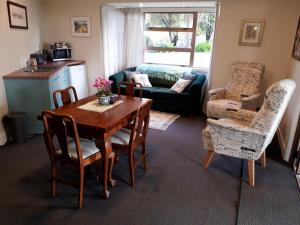 a living room with a table and chairs at The Rise in Napier
