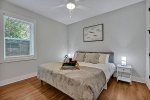a white bedroom with a bed and a window at Nashville - 805B Bradford Ave #102 in Nashville