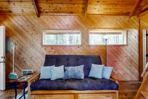 a blue couch in a room with wooden walls at Schillinger Fields in Toledo