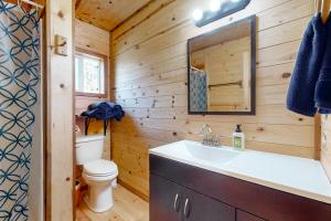 a bathroom with a sink and a toilet in a log cabin at Schillinger Fields in Toledo