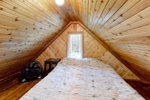 a bed in a wooden room with a window at Schillinger Fields in Toledo