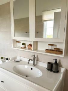 a bathroom with a sink and a mirror at Finca Jasmat in Cabrera