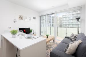 a kitchen and living room with a couch and a table at 1BD Perfect location Walk to CN Tower! in Toronto