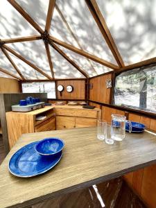 un tavolo in legno con piastre blu sopra di Glamping en la Sierra de Arteaga a Los Lirios