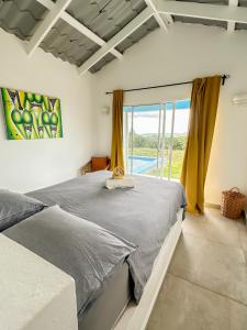 a bedroom with a bed and a large window at Finca Jasmat in Cabrera