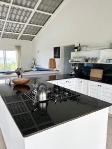 a kitchen with a stove and a counter top at Finca Jasmat in Cabrera