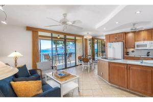 a kitchen and living room with a couch and a table at KIHEI BEACH #504 condo in Kihei