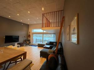 a living room with a couch and a table at Rosie’s Neyst in Vestmanna