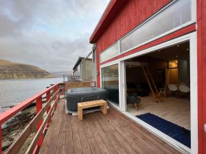 a deck of a boat with a large sliding glass door at Rosie’s Neyst in Vestmanna
