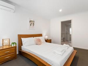 a bedroom with a bed with two towels on it at Three Bedroom, Two Bathroom Family Home in Coogee
