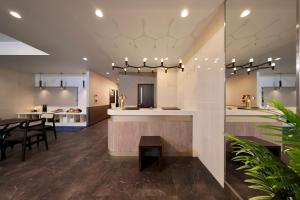 a kitchen and dining room with a table and chairs at Tennouji Crystal Hotel in Osaka