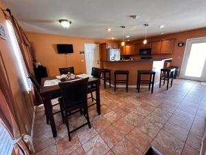 a kitchen and dining room with a table and chairs at A huge Sprawling House on a large lot -15 minutes to St Louis in Belleville