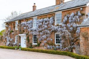 an old brick house with a painting on the side of it at Stunning 6-bed country house with heated pool in Headcorn